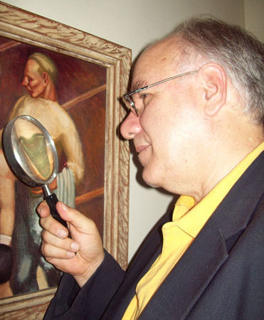 Art appraiser using magnifying glass to determine value.