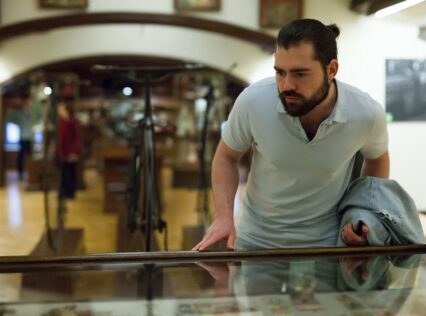 Adult man looking at artwork in a museum