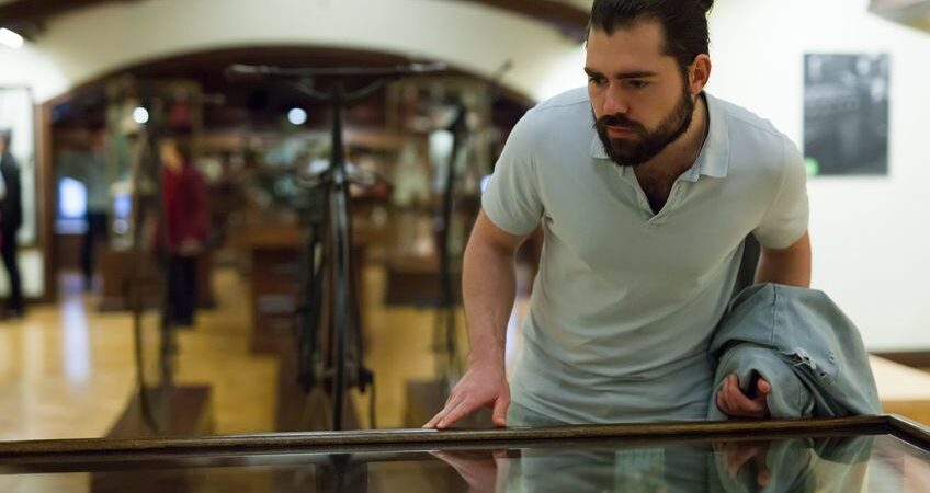 Adult man looking at artwork in a museum