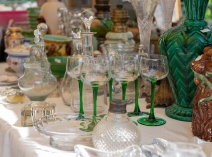 A table of antiques waiting to be appraised.