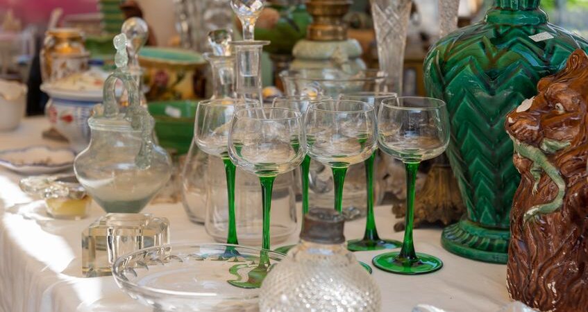 A table of antiques waiting to be appraised.